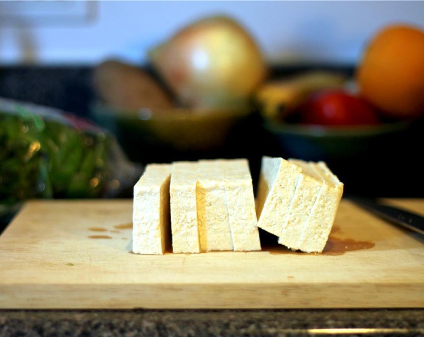 step 2 Slice Extra Firm Tofu (1/2 pckg) into four even slabs and place between multiple layers of paper towel, pressing to absorb the liquid.