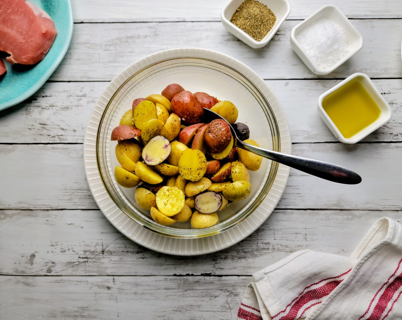 step 2 Line a rimmed sheet pan with parchment paper. Cut the Mixed Baby Potatoes (4 1/2 cups) in half and place the potato halves in a medium mixing bowl. Toss them with Olive Oil (1 Tbsp). Then, season the potato halves with Kosher Salt (1 tsp), Ground Black Pepper (1 tsp), and McCormick® Garlic Powder (1 tsp). Toss again to make sure they are all coated nicely.