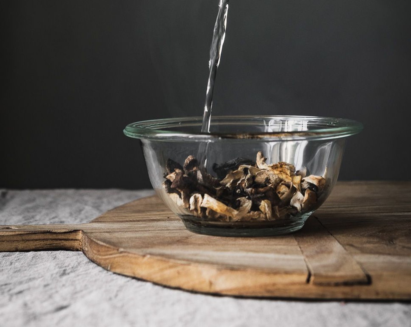 step 4 Remove the Dried Mushrooms (1/4 cup) from the hot water. Reserve the soaking water, and finely chop the mushrooms. Add to the pot and increase the heat to medium-high.