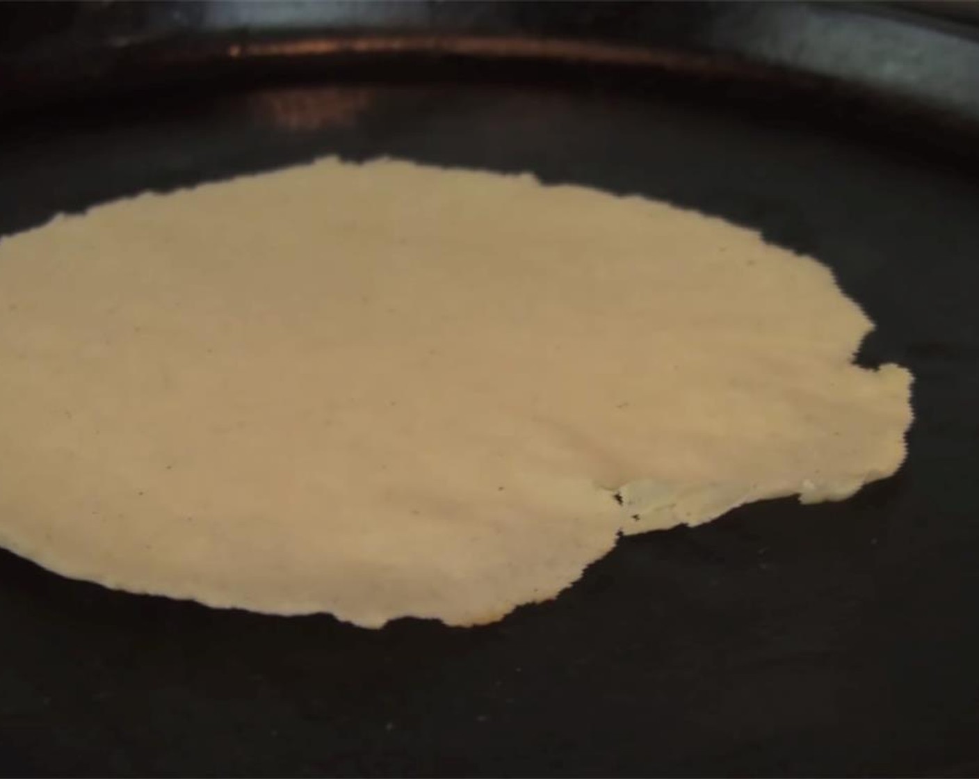 step 7 Heat cast iron pan over medium heat. Lay tortilla onto pan, and let sit until the edges start to lift up. Flip, and let cook another 1 to 1 1/2 minutes. Remove from heat, and repeat with rest of dough. Enjoy!