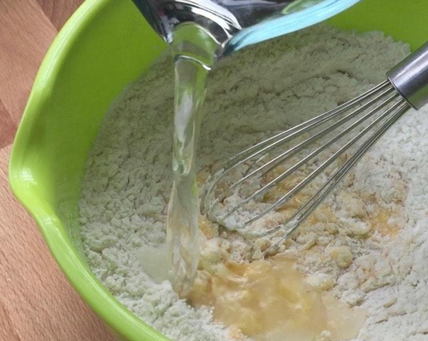 step 3 Using a whisk, stir in one direction to mix in flour. Then in batches, slowly add in Water (3/4 cup).