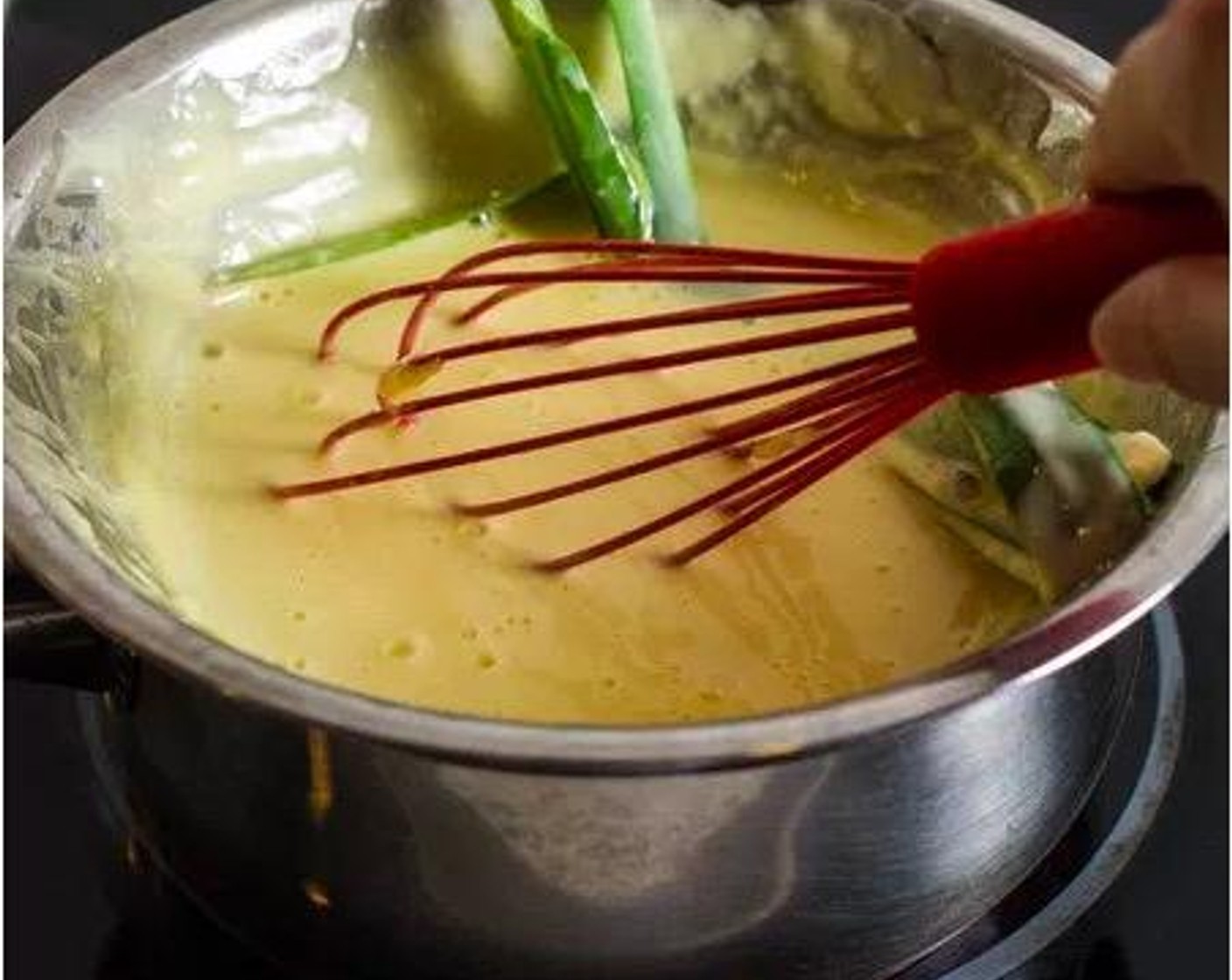 step 3 Fill a small saucepan with approximately 2 inches of water and bring it to a light boil over medium-high heat. Set the bowl with your kaya mixture over the saucepan. Whisk the kaya mixture frequently for 5 minutes.