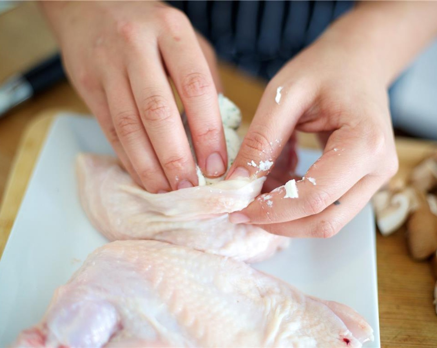 step 8 Divide the herb-cheese blend in half, and roll each half into a log shorter than the length of the chicken breast. Insert cheese into the small pocket under the skin, close pocket, and press down on skin to flatten cheese the cheese in the breast. Repeat with second breast.