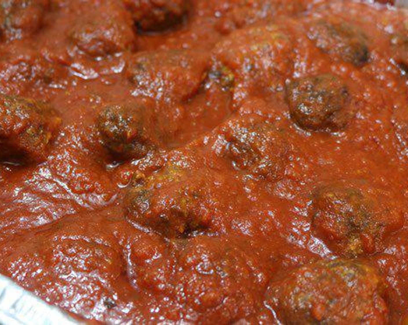 step 4 Once the Meatballs are brown and smoked, pull them off and add them to a small pan and cover with your Marinara Sauce.