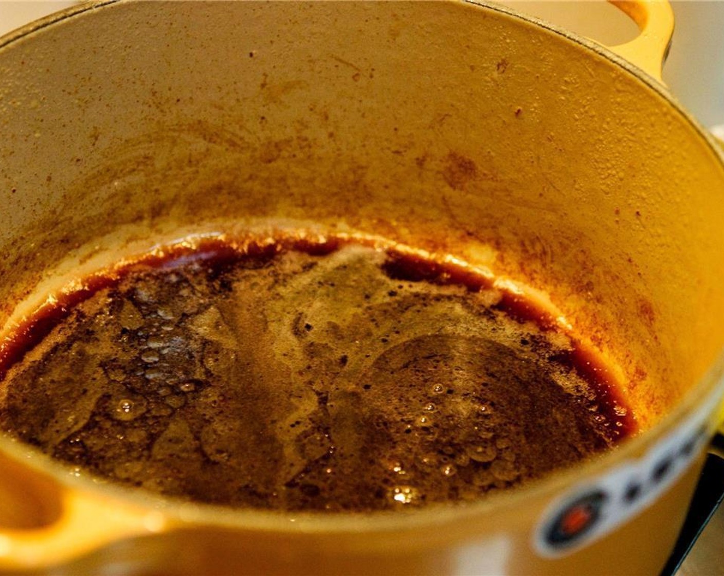 step 5 Pour the Red Wine (2 cups) into the pot to deglaze it. Use a wooden spoon to scrape the bottom.