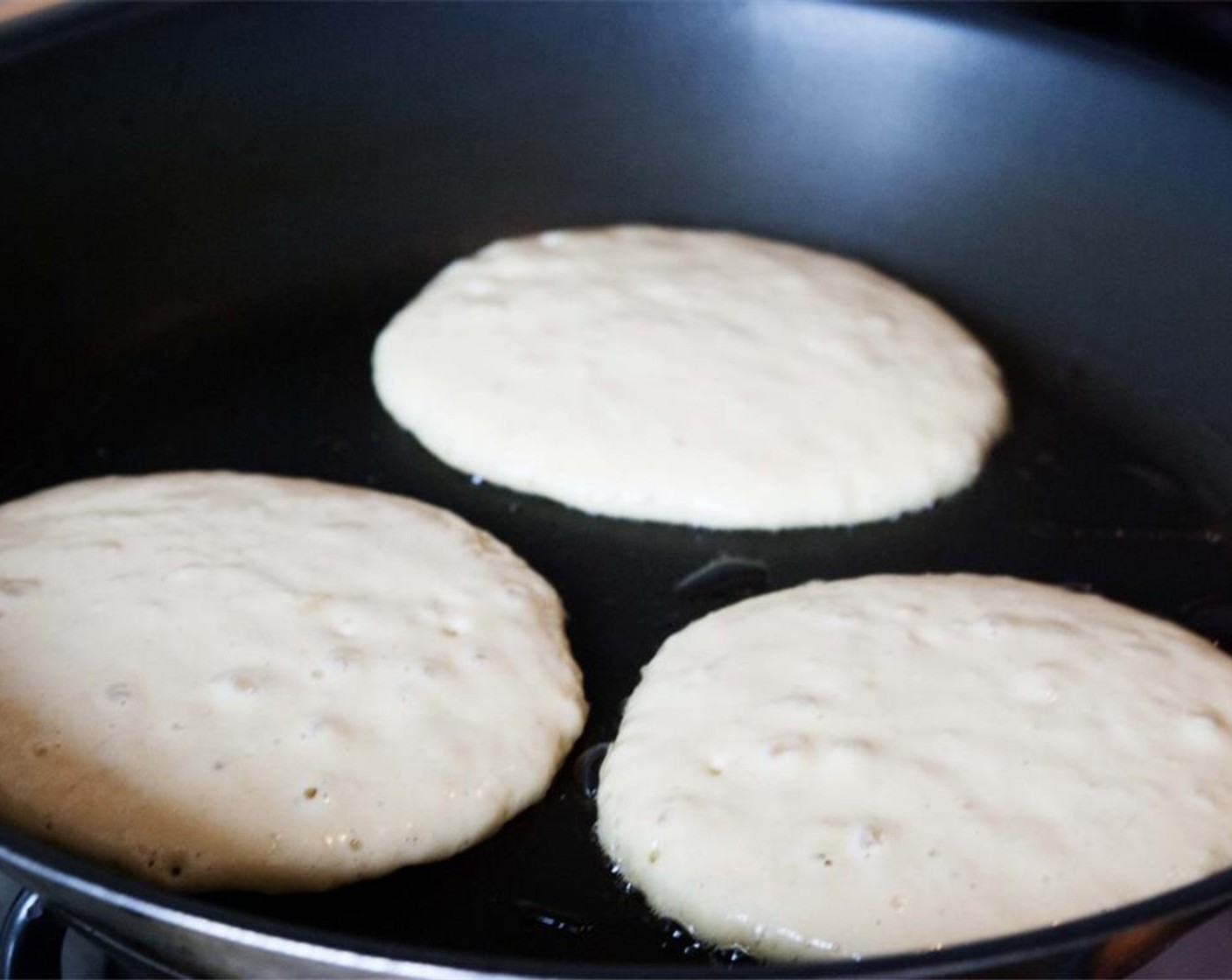 step 5 Heat a nonstick pan over medium heat. Ladle 1/4 cup of batter onto the pan for smaller pancakes. Cook on one side until the edges are just set and tiny bubbles appear on the surface of the pancake, about 2 minutes.