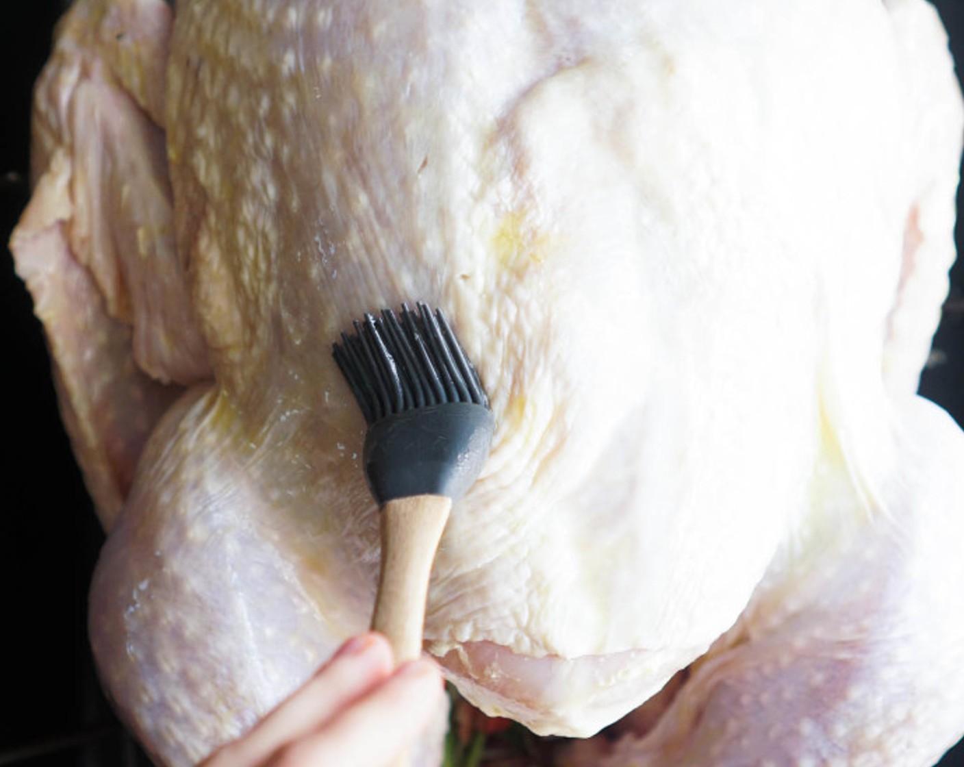 step 11 Tuck the wings under the bird, tie the legs with kitchen twine, and coat the skin liberally with Olive Oil (as needed).