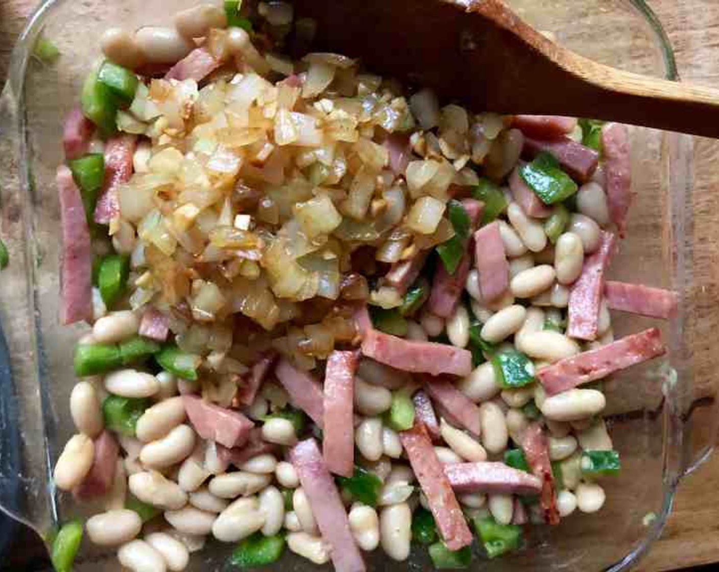 step 3 In a 1-1/2-quart casserole dish combine Cannellini White Kidney Beans (2 cans), ham, onion, and garlic mixture, chopped sweet pepper, Yellow Mustard (2 Tbsp), Apple Cider Vinegar (2 Tbsp), Pure Maple Syrup (2 Tbsp), and Worcestershire Sauce (1 Tbsp). Cover and refrigerate overnight (up to 24 hours).