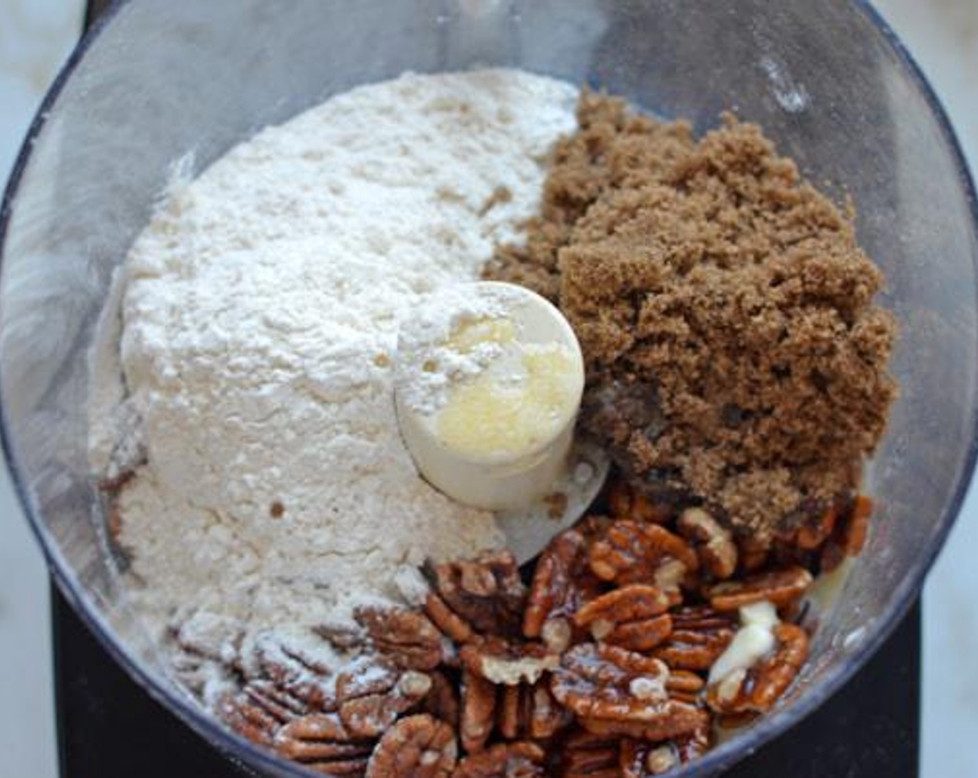 step 2 Combine the Pecans (100 g), All-Purpose Flour (125 g), Brown Sugar (80 g), Unsalted Butter (4 Tbsp), and Salt (1 pinch) in the bowl of a food processor fitted with the steel blade.
