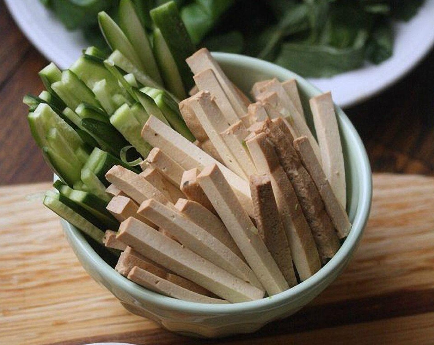 step 1 Arrange the Smoked Tofu (1 cup), Seedless Cucumber (1), Carrots (2), Fresh Cilantro (1 bunch), Fresh Thai Basil Leaves (1 cup), and Fresh Mint Leaves (1 cup) in neat piles on a plate or shallow bowl.