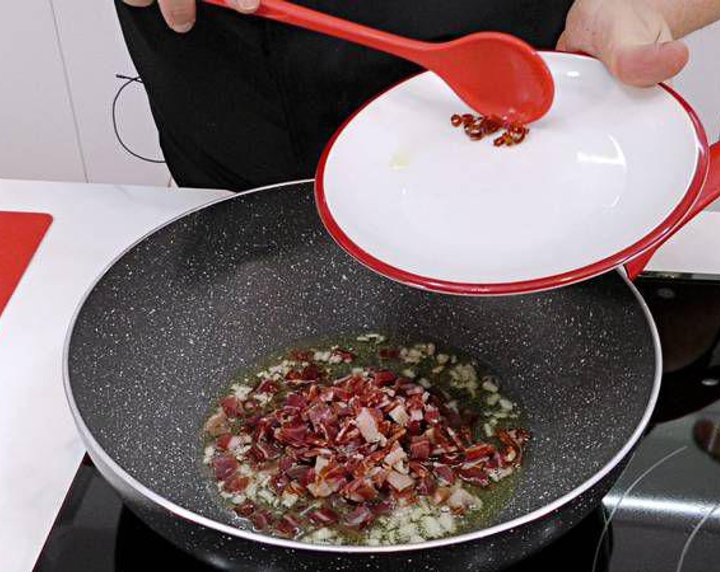 step 1 Fry the Garlic (2 cloves) in a hot pan with some Olive Oil (as needed). Once the garlic starts changing to a golden color add the Serrano Ham (3.5 oz) and season with Cayenne Pepper (to taste) and Salt (to taste).