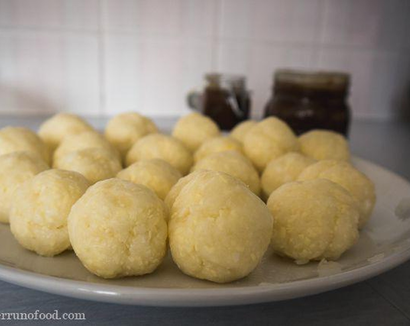 step 4 Make all the balls (as big or small as you like) and deep fry them in the hot Vegetable Oil (as needed) until they are golden brown, approx 8 to 10 minutes. Once done, drizzle, smoother, or dip them in the caramel sauce. Serve and enjoy!