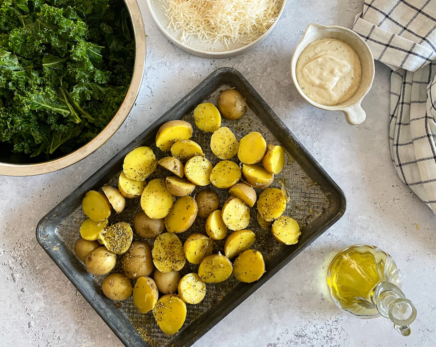 step 4 Spread them out onto a baking tray and season well with Lemon Pepper (1/2 Tbsp) and 3/4 of Olive Oil (1/4 cup).