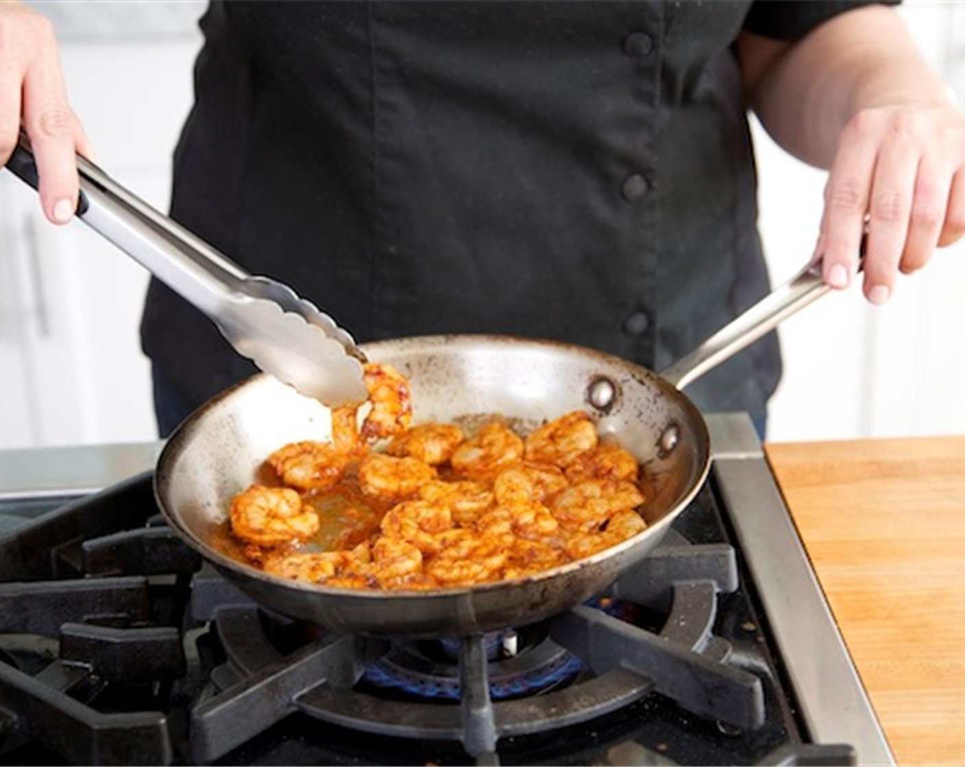 step 8 Heat the same medium saute pan over high heat. Add the shrimmp in a single layer with the marinade. Cook for one and half minutes on one side, then turn over and cook for thirty seconds until shrimp are cooked through. Remove from heat.