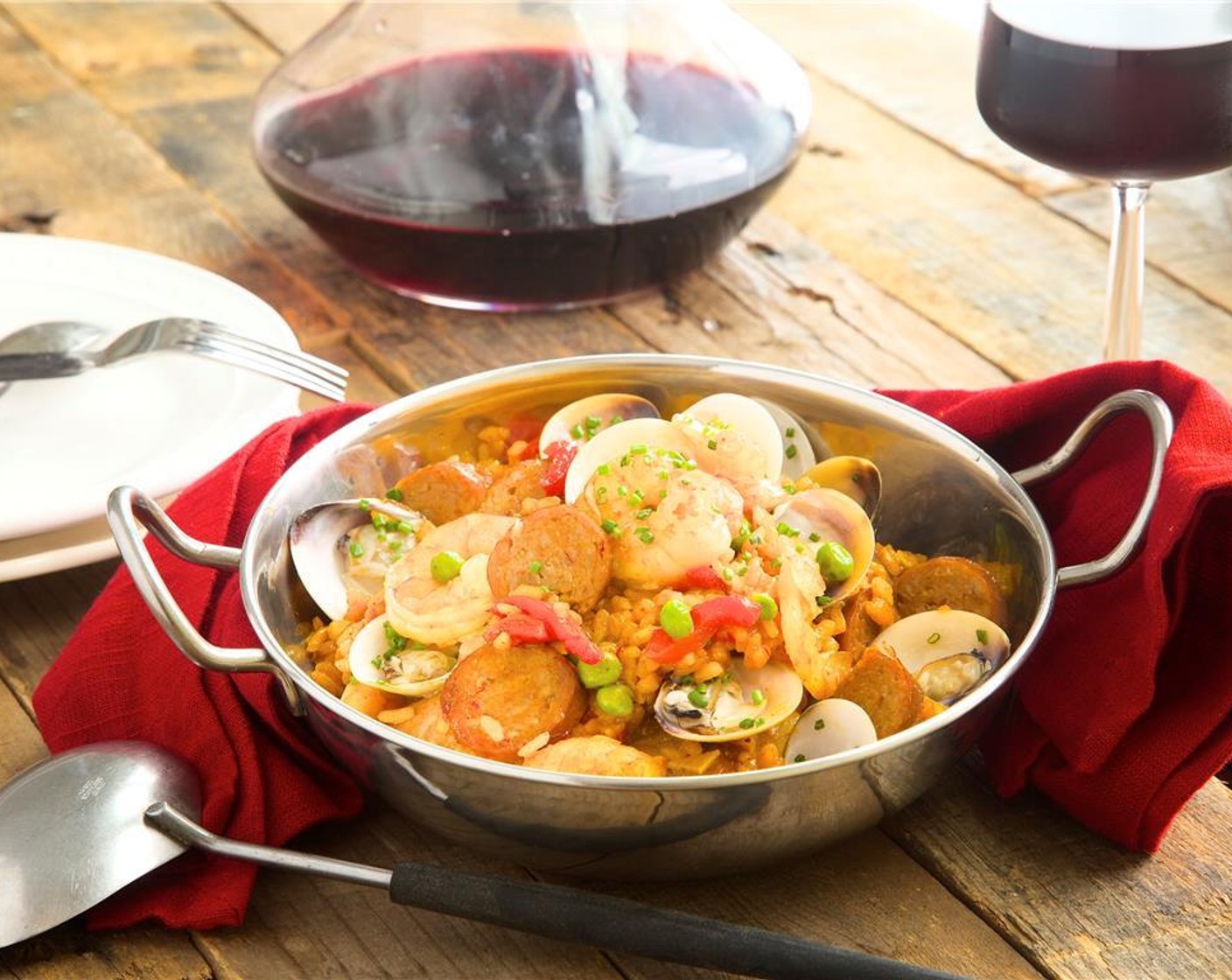 step 16 Spoon paella into the middle of a bowl, then gently place shrimp and chorizo on top. Arrange reserved half shelled clams in center and around the dish. Garnish with Fresh Chives (6 stalks).