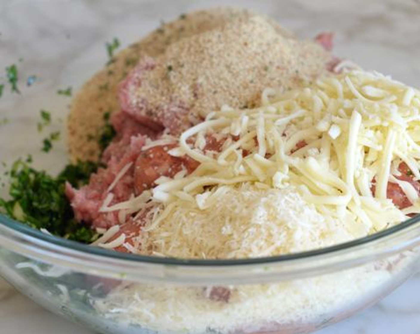 step 3 Add the 93/7 Lean Ground Turkey (1.3 lb), Italian Turkey Sausages (1.3 lb), Shredded Mozzarella Cheese (1 cup), Parmigiano-Reggiano (1 cup) and Italian-Style Breadcrumbs (1 cup). Using your hands, mix until evenly combined.