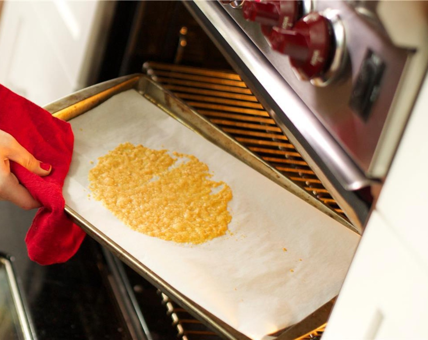 step 5 Line a sheet pan with parchment paper. Pour 2 tablespoons of Parmesan Cheese (1 1/2 cups) evenly onto the paper to create one large, thin snowflake. Bake for 3 minutes.