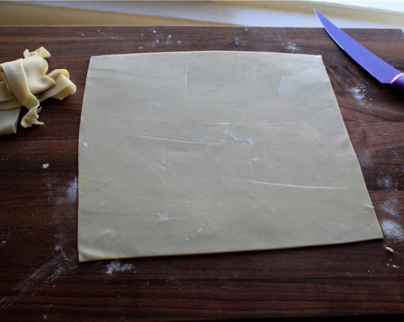 step 2 Roll out a single Pie Crust (1) into 1/4-inch thick sheet of dough. Trim around the edges to square it off.