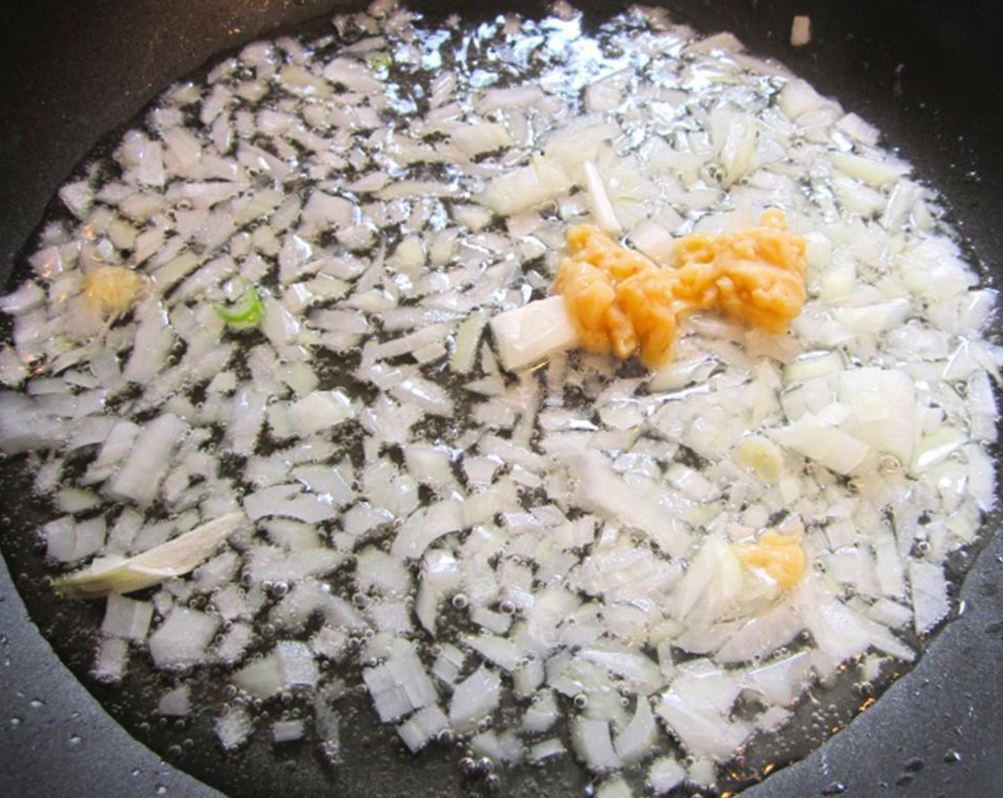 step 2 Sautee diced White Onion (1/2) and Garlic Paste (2 tsp) in Extra-Virgin Olive Oil (1 Tbsp) until onions are slightly softened.