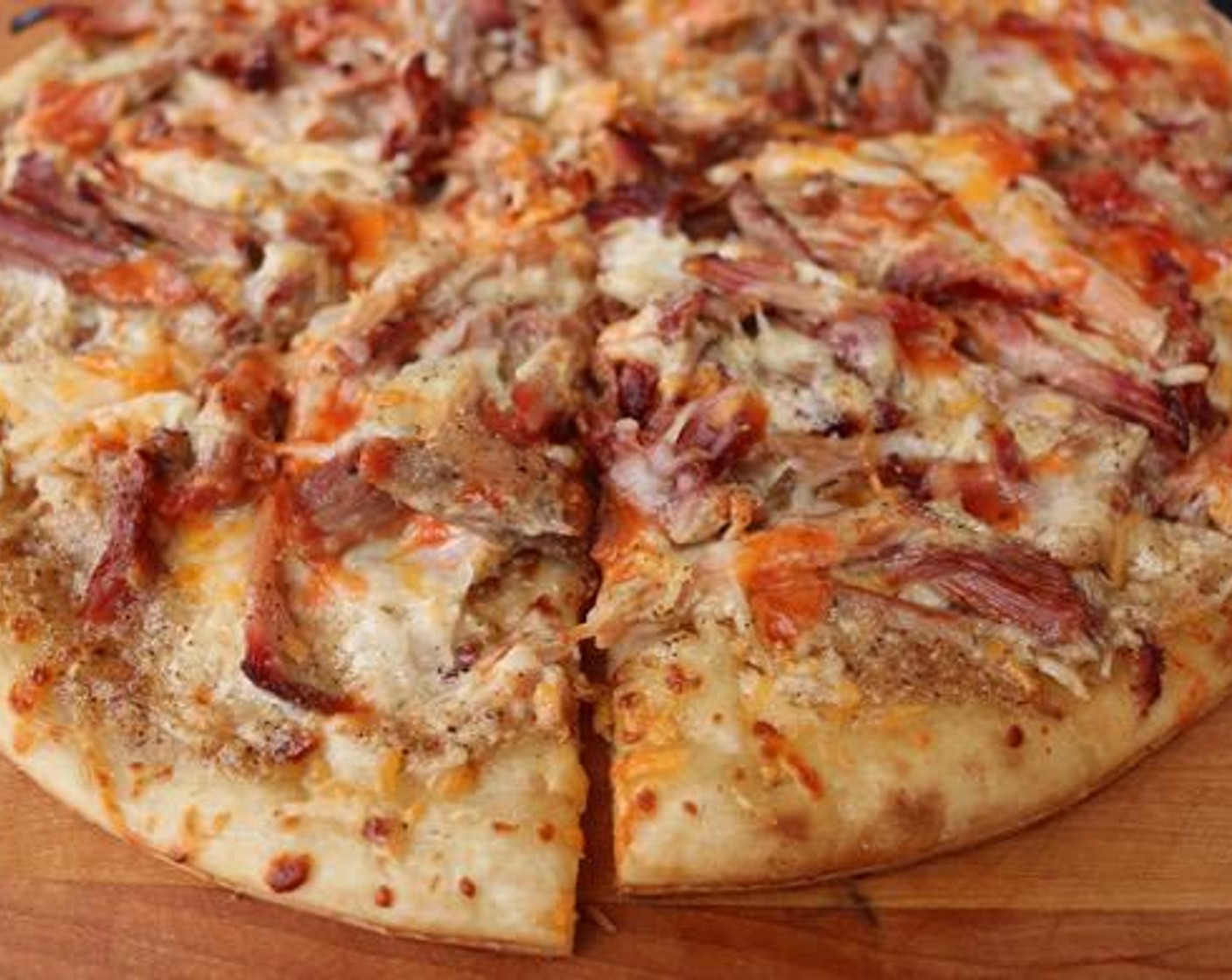 step 6 Remove from grill and drizzle Hot Sauce (4 Tbsp) over the top. Slice the pizza and serve. Enjoy!