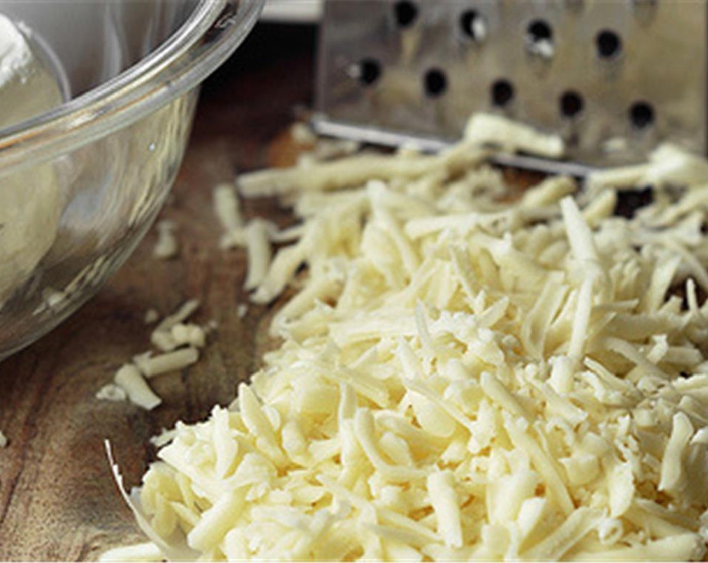 step 2 Shred the Monterey Jack Cheese (1 cup). Crumble the Queso Fresco (4 Tbsp). Soften the Cream Cheese (1 cup). Chop the Yellow Onion (1) and Garlic (2 cloves).