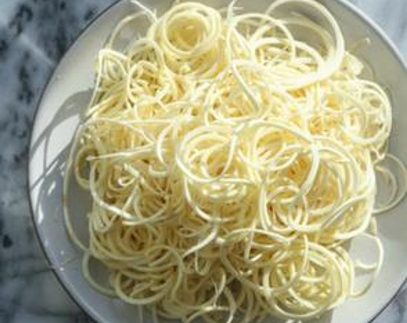 step 1 In a large nonstick skillet, heat Olive Oil (1 Tbsp). Sauté the Parsnips (4) noodles over medium-high heat until soft, about 5 minutes. Season lightly with Sea Salt (to taste) and transfer to a mixing bowl.