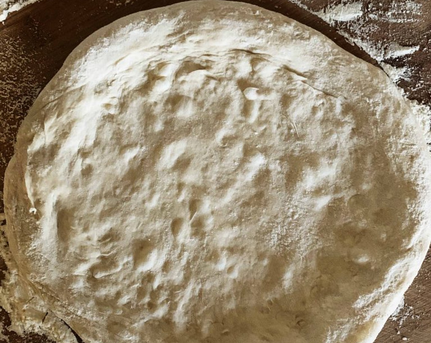 step 9 Turn the dough onto a floured surface and gently shape it into a 12-inch circle. Make soft and gentle movements going from the center toward the edge, trying to push the air bubbles inside the dough towards the edges, this will give you those typical holes which we all love in pizza.