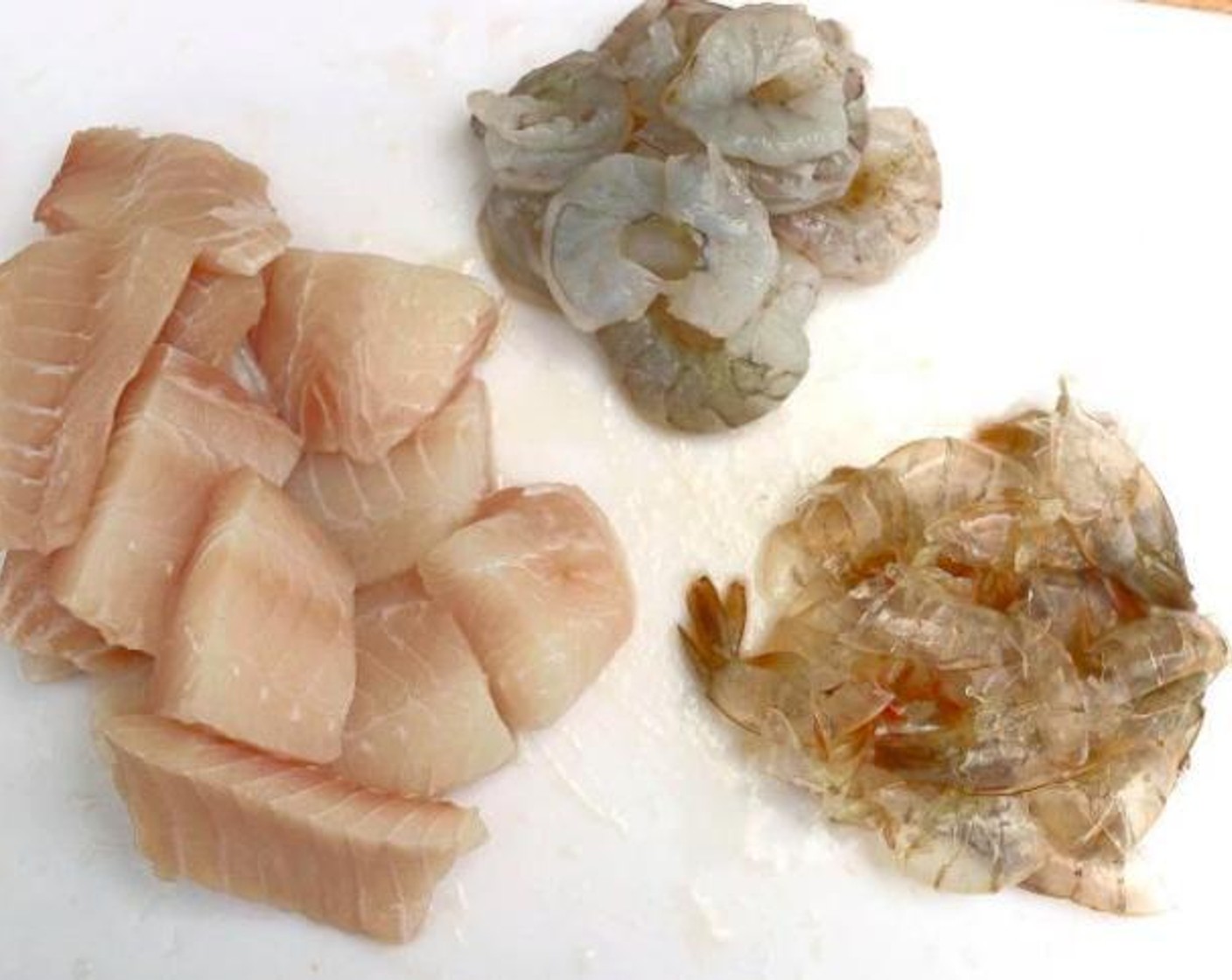 step 2 Cut the fish fillets into large pieces. Peel Shrimp (12 oz) and remove tails. Save the shell aside.