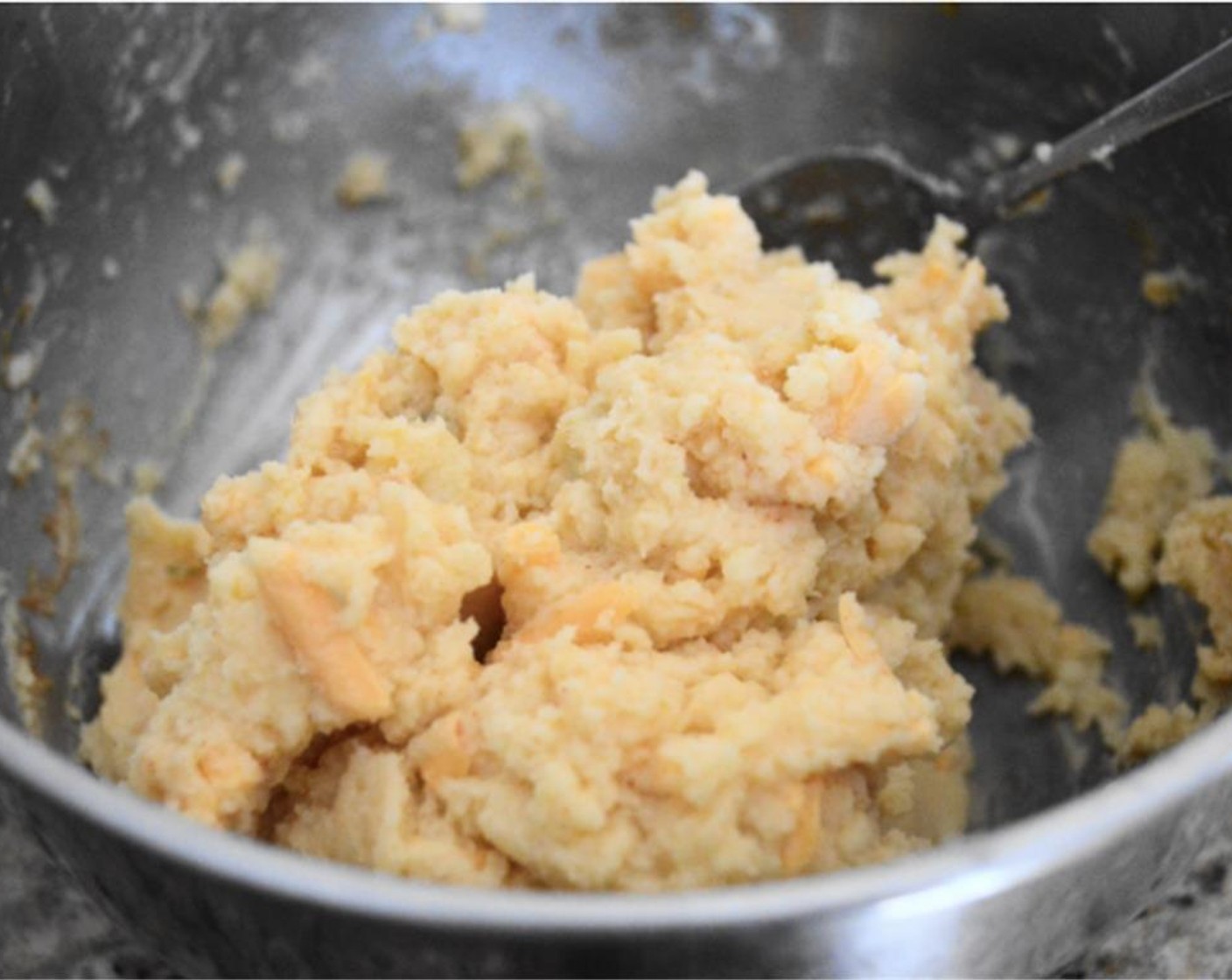 step 1 Combine Mashed Potatoes (1 2/3 cups), All-Purpose Flour (1 1/3 Tbsp), Milk (1 Tbsp), Shredded Extra Sharp Cheddar Cheese (1/3 cup), Fresh Rosemary (1/2 tsp), Dried Onions (1/2 tsp), Smoked Paprika (1/4 tsp), Salt (1 pinch) and yolk of an Eggland's Best Classic Egg (1). Mix until smooth and uniform.