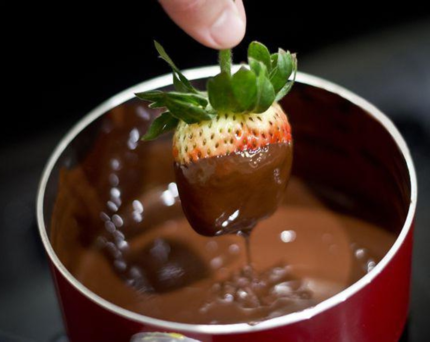 step 2 Remove from heat once completely melted. Dip Fresh Strawberries (10) into chocolate, allowing excess to drip off before placing on a sheet of wax paper.