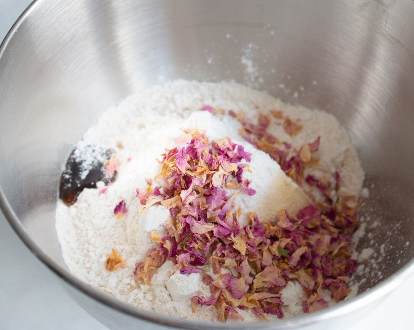 step 2 Add Unsalted Butter (1 cup), Granulated Sugar (2/3 cup), All-Purpose Flour (2 1/3 cups), Vanilla Extract (1/2 tsp), Rose Water (3/4 tsp), Salt (1/4 tsp), and Edible Dried Rose Petals (3 Tbsp) into a mixing bowl. Mix on low for 2 minutes until the mixture is a coarse crumbly texture. Add Heavy Cream (3 Tbsp) and mix for 30 seconds.