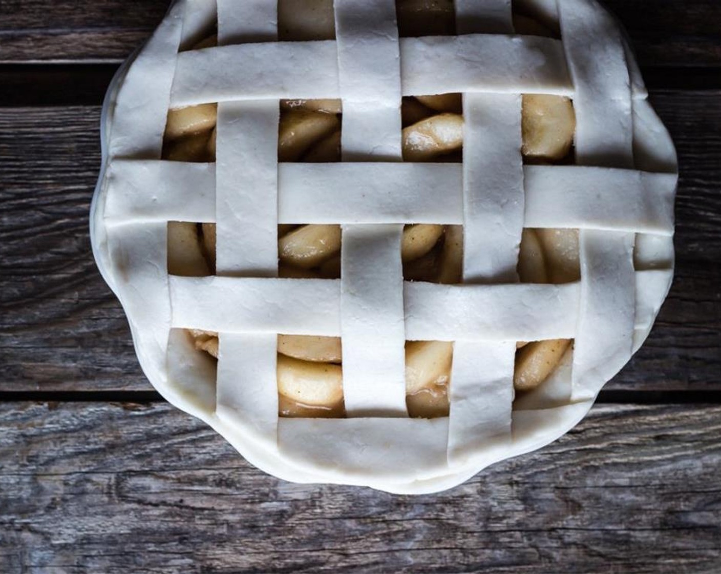 step 9 Carefully lift the lattice with the parchment paper and roll it onto the top of the pie.