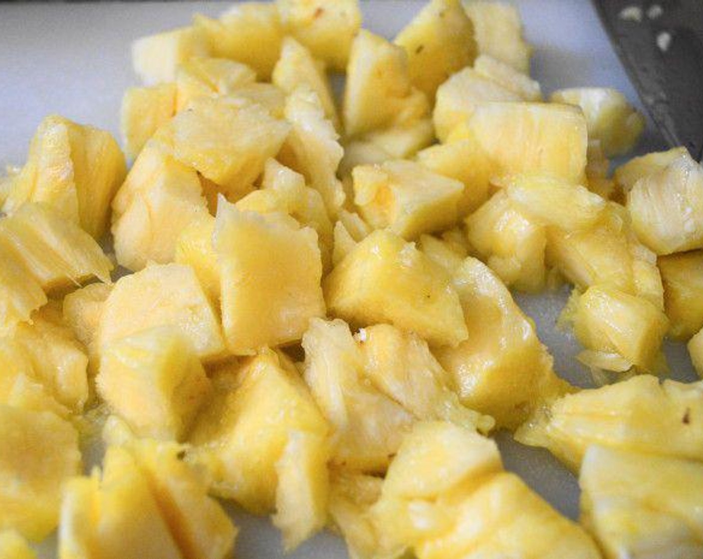 step 1 Heat the Butter (4 Tbsp) in a large rondeau pan over medium-high heat. Lightly cook the Fresh Pineapple Chunks (2 cups) in it for about a minute, then remove it with a slotted spoon and set it aside.