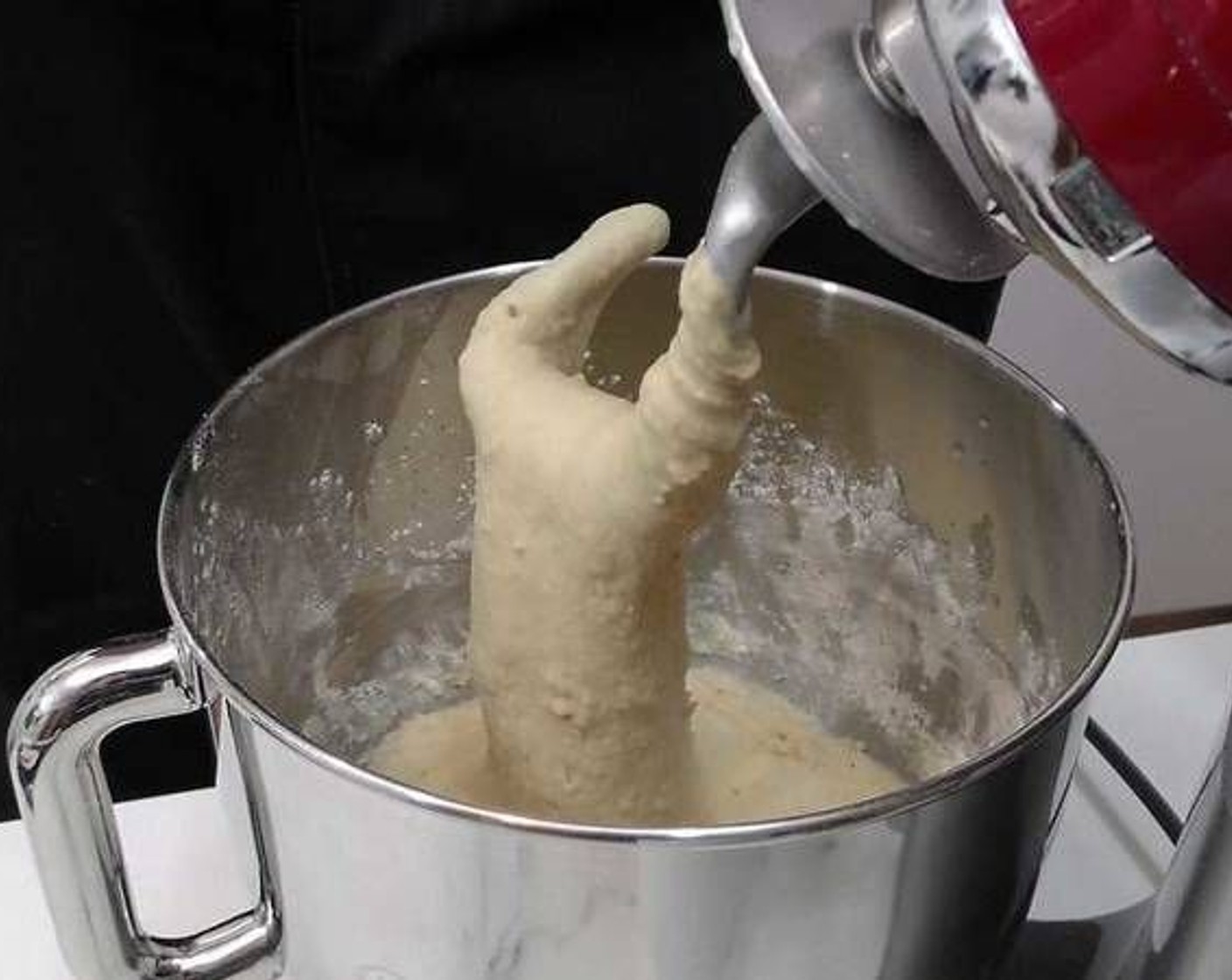 step 4 Once the dough is well-mixed we can begin to knead. If you touch it, you'll notice it's quite sticky which is why we must knead by hand.