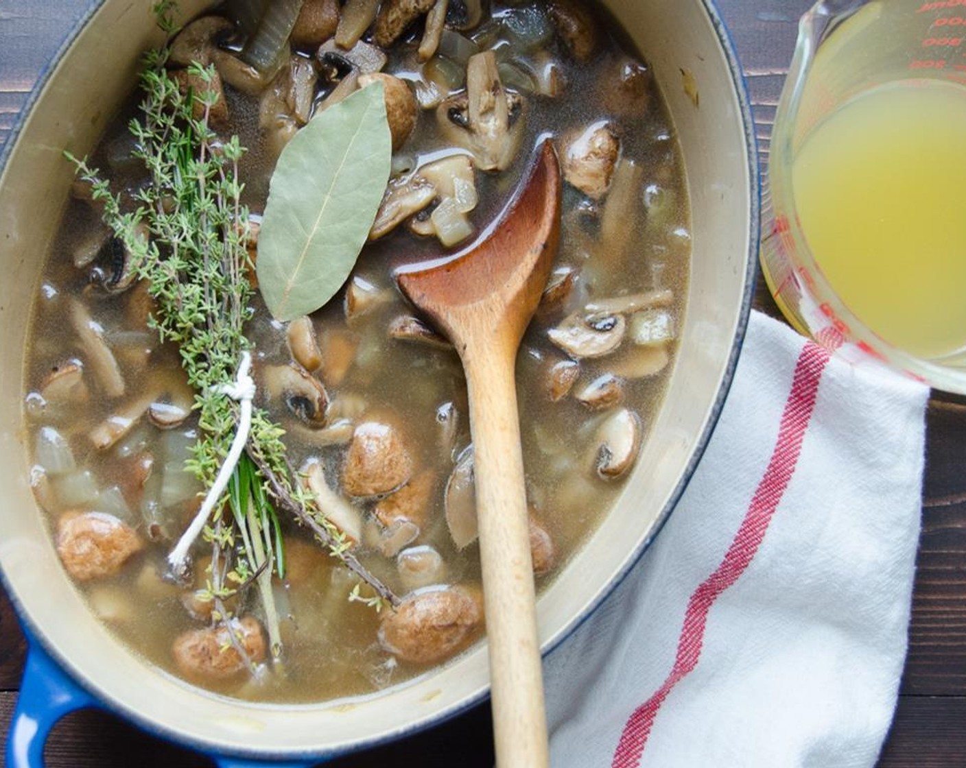 step 4 Add the Bay Leaf (1), Vegetable Broth (2 cups) and rosemary-thyme bundle to the mushrooms.