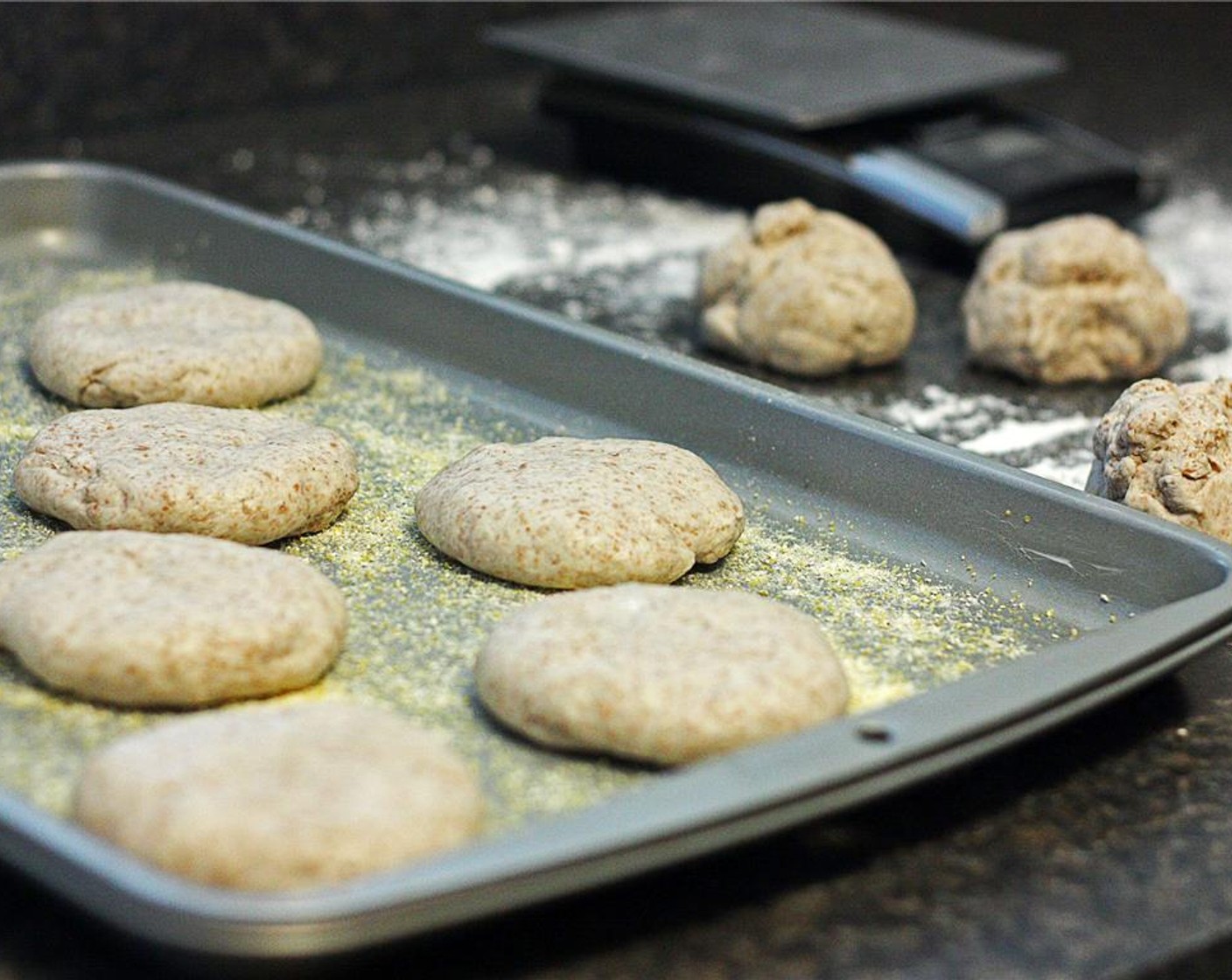 step 7 Roll each piece into a ball and flatten between your palms, forming a disc about three inches across. Place each disc on the cookie sheet at least an inch apart. Cover lightly with plastic wrap and let rise for at least 2 hours.