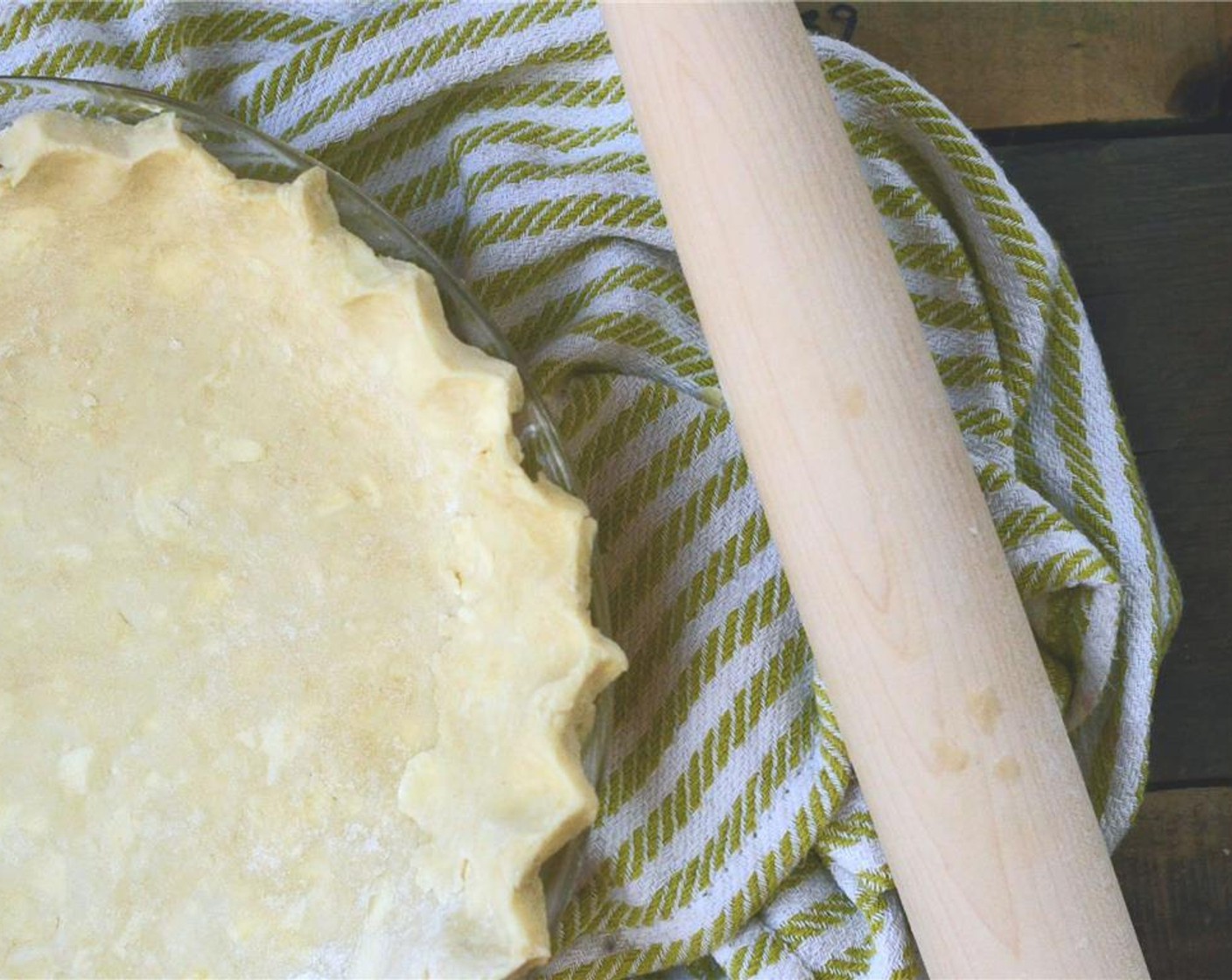 step 9 Fit dough into a 9 inch pie plate, trim off excess dough around edges - leaving about 1/2 inch overhanging the edge. Place pie plate in freezer for 15 minutes. Prepare filling.