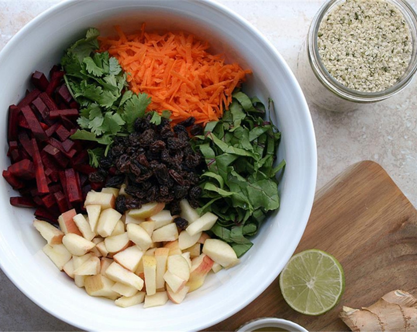 step 6 Place the carrots, apples, beets, chopped greens, Golden Raisins (1/2 cup), and cilantro in a large bowl.