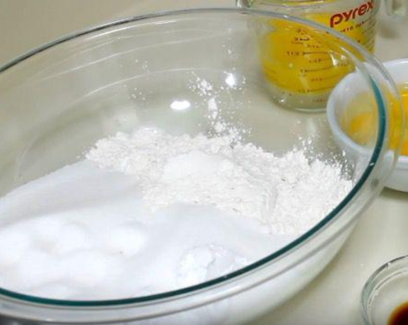 step 1 In a mixing bowl, add All-Purpose Flour (2 3/4 cups), Granulated Sugar (2 cups), Salt (1/2 tsp), Baking Soda (1/2 tsp), and Baking Powder (1/2 Tbsp). Whisk together and set aside.