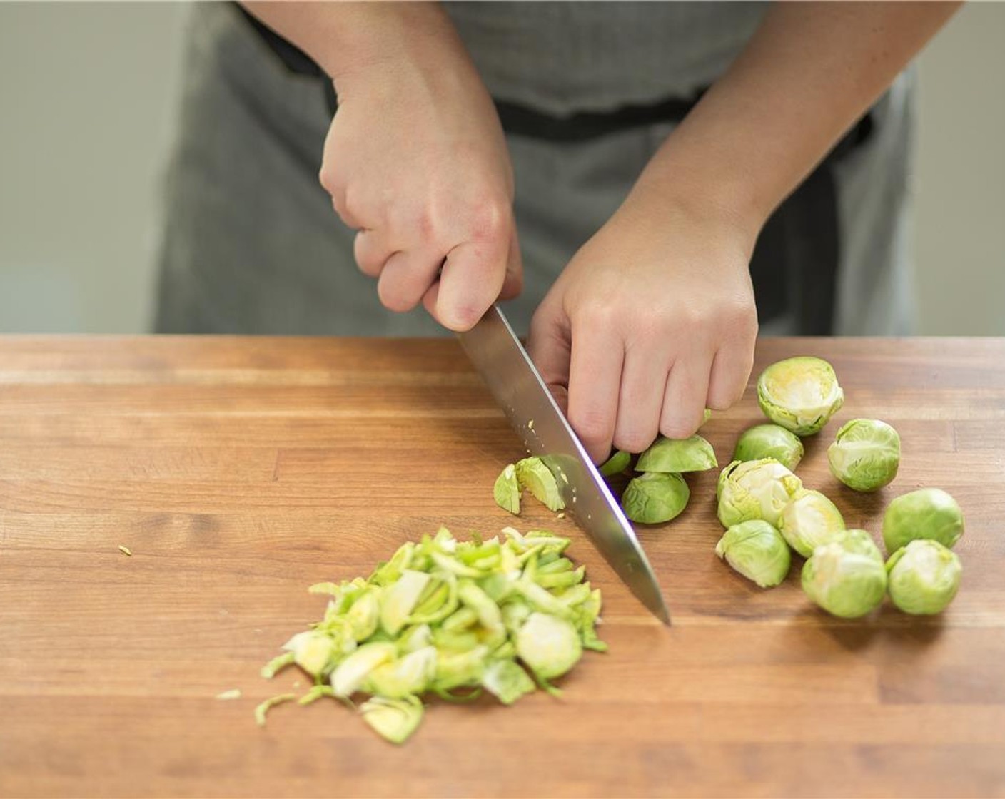 step 1 Cut Brussels Sprouts (3 3/4 cups) in half then slice into quarter-inch shreds with the flat side down.