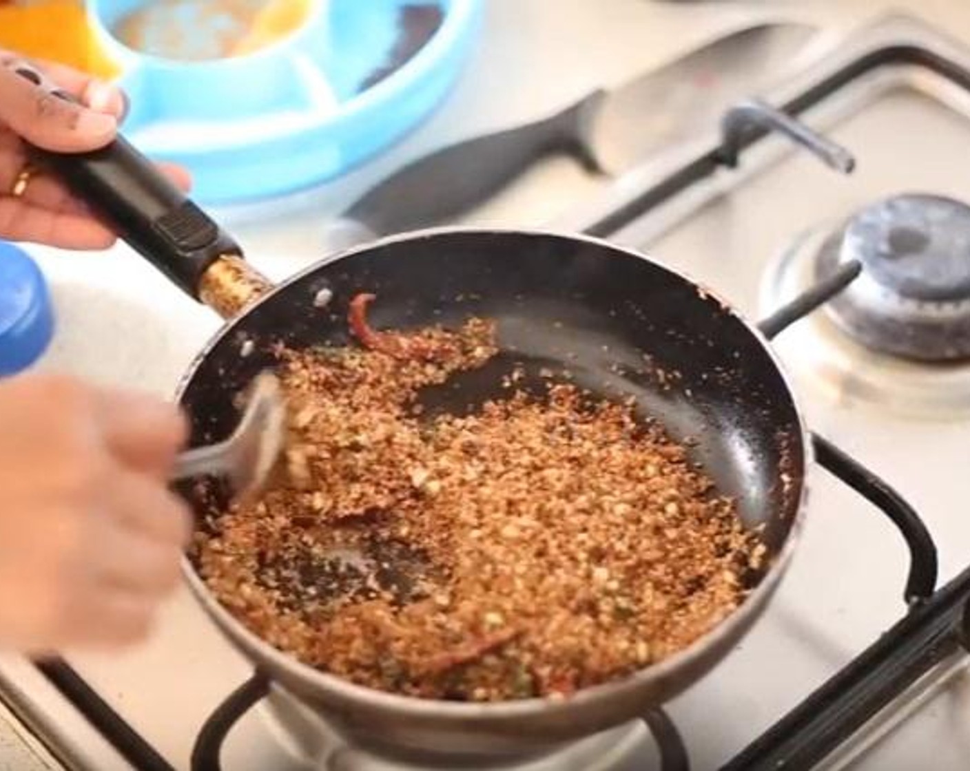 step 4 On a separate frying pan add the Coconut Oil (0.5 oz), Fennel Seeds (3/4 tsp), Peppercorns (3/4 tsp), Red Chili Peppers (2), Desiccated Coconut (1 cup), Curry Leaf (1), and Whole Coriander Seeds (1/2 tsp). Saute until a light brown texture is formed.