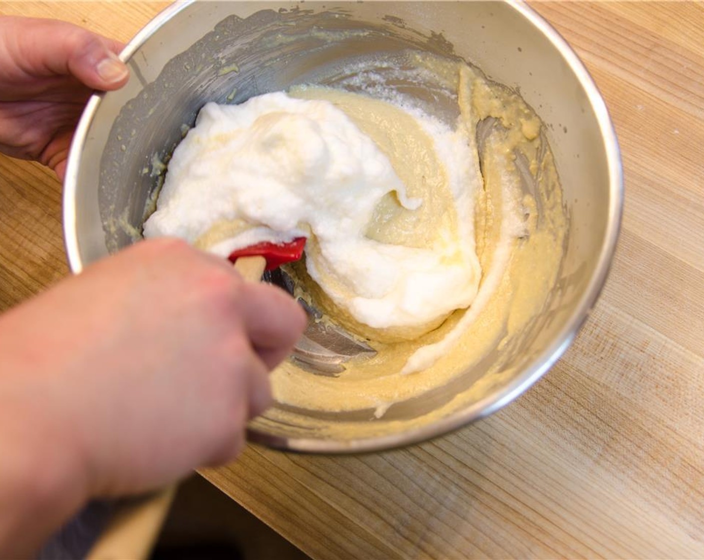 step 8 Fold the remaining stiff whites into the yolk mixture with the rubber spatula.