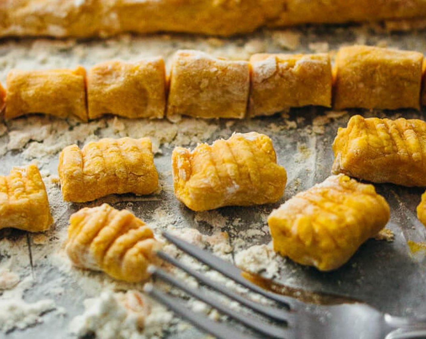 step 5 Divide the dough ball into 4 pieces. Take a piece and form a long log about a half inch wide. Cut the log into pieces about one inch long, which will be the individual gnocchi pieces. Repeat for the other three dough pieces. In total, there should be 40 gnocchi pieces.