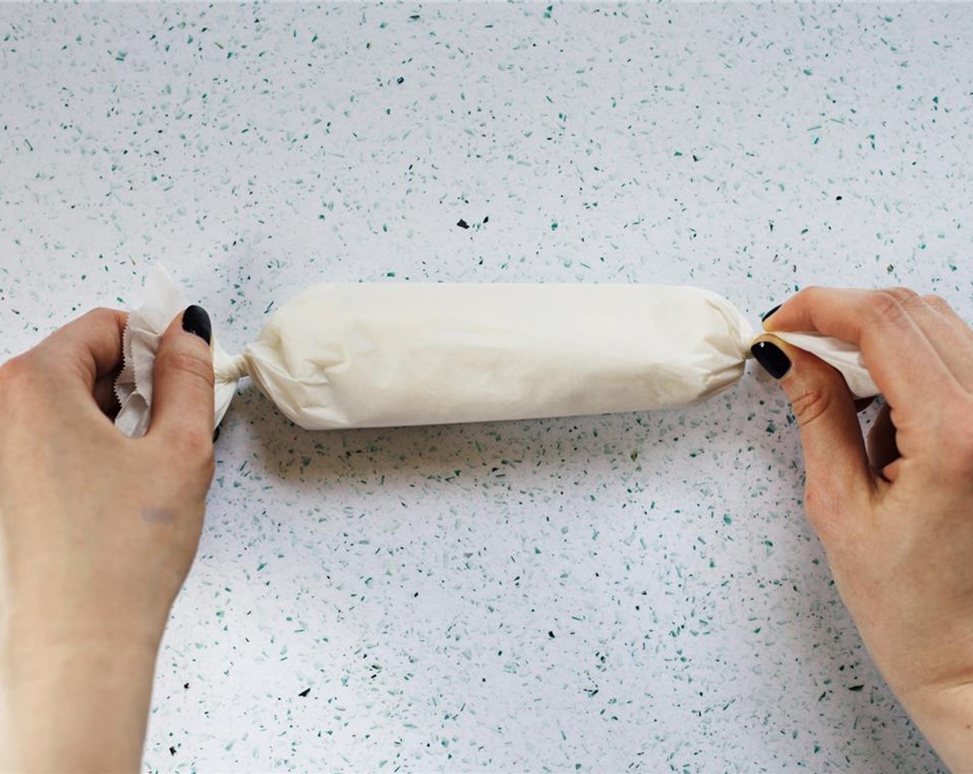 step 8 Twist the ends of the parchment together to seal the butter in.