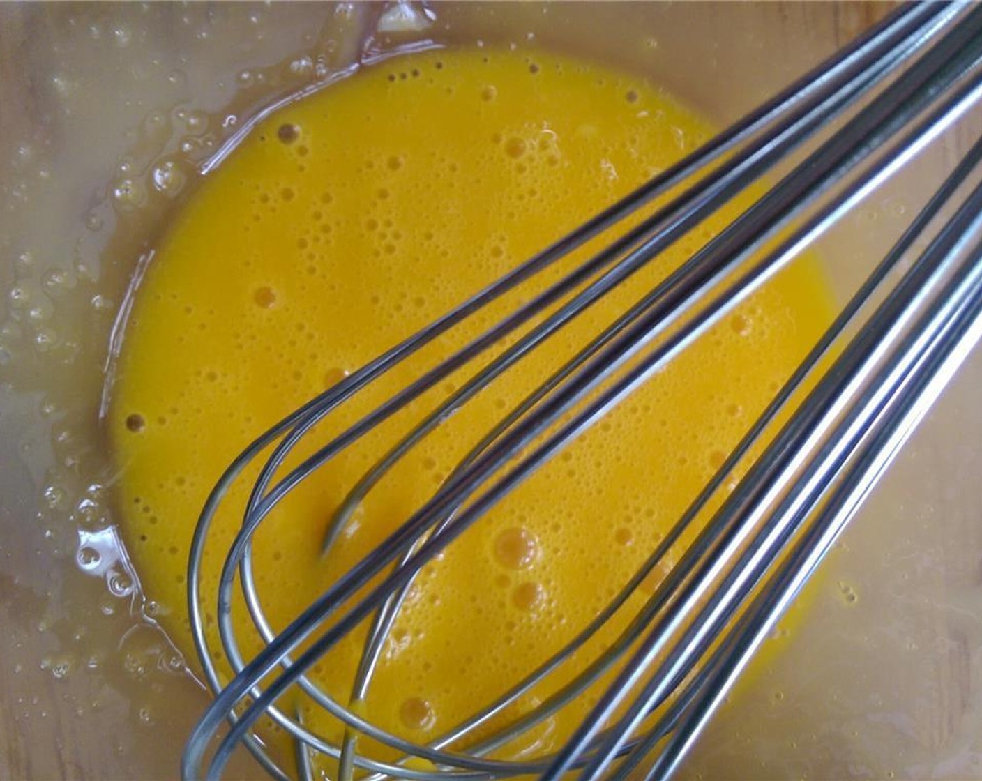 step 4 While syrup mixture is warming, whisk Eggland's Best Classic Eggs (4) a medium bowl.