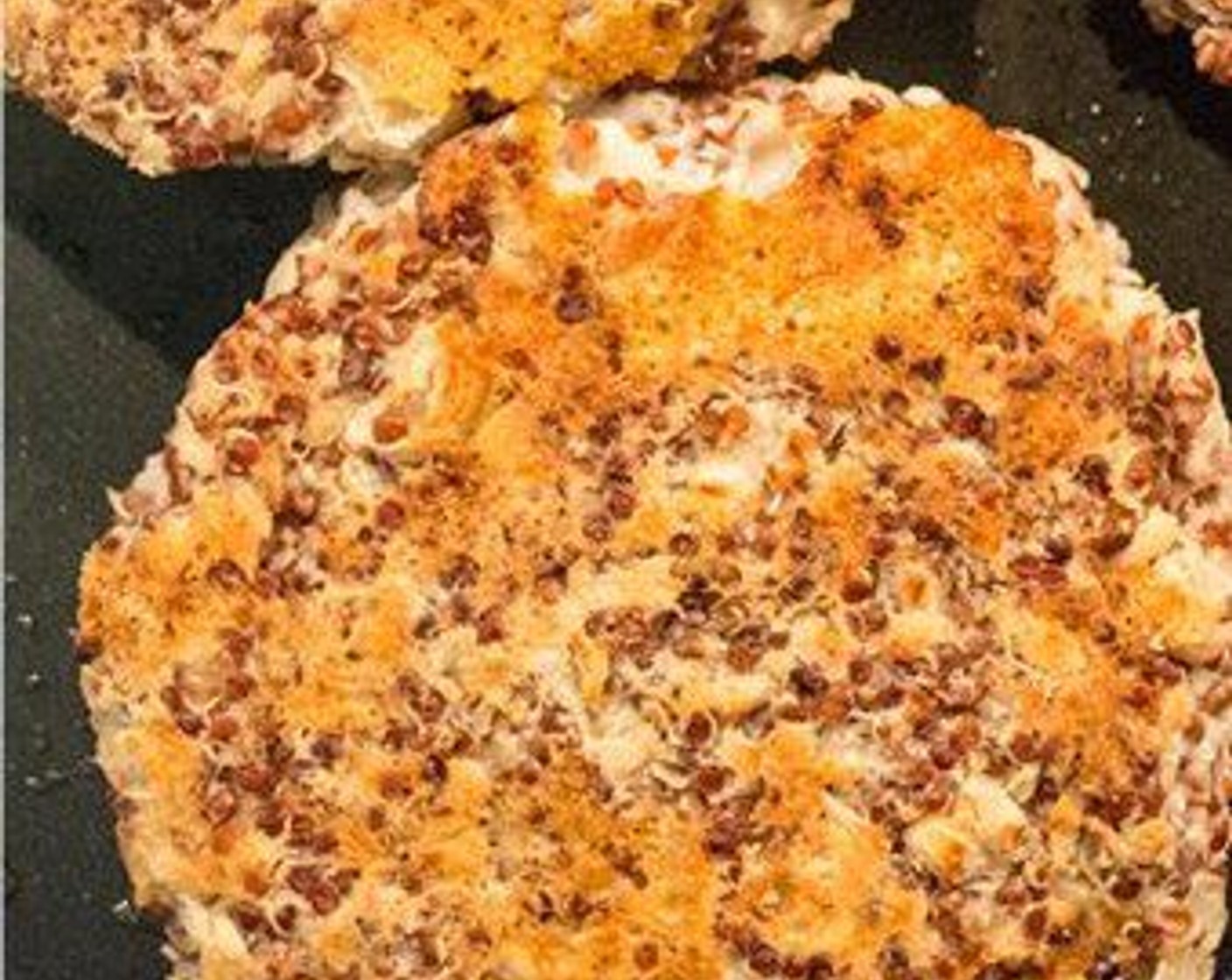 step 9 For the Burgers: While the onions are caramelizing, spray another pan with coconut oil cooking spray, remove quinoa burgers from fridge, add to skillet and cook until golden and crisp, about five minutes per side. During the last minute or so of cooking add the Muenster Cheese (6 slices), cover the pan and cook 2-3 minutes or until the cheese has melted.