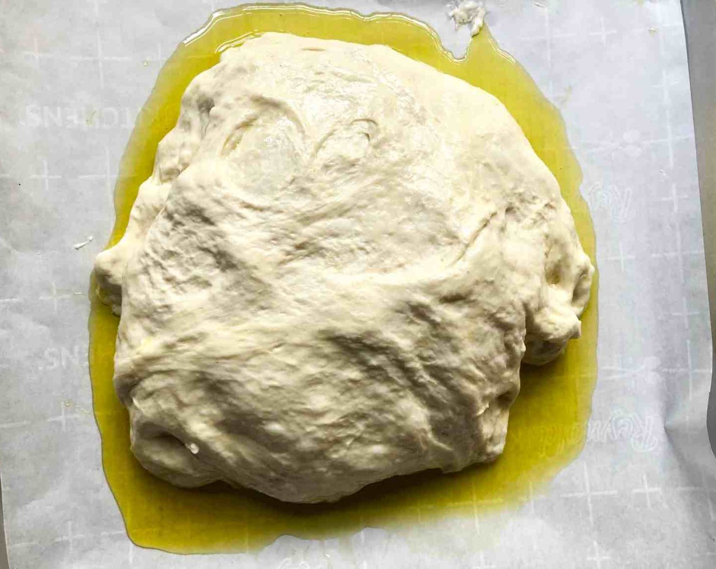 step 10 Use the forks to lift the dough onto the oil on the prepared sheet. Roll the dough ball in the oil to coat it all over. Let it rest uncovered, without touching it, for 20 minutes.