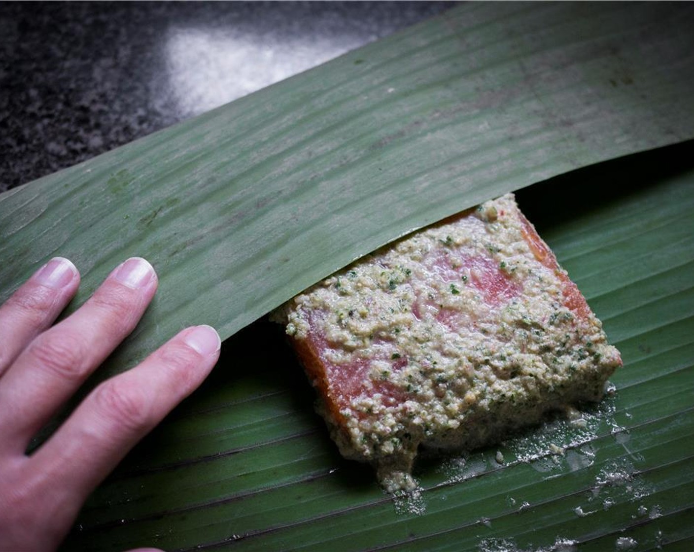 step 5 Place each fish fillet in the middle of one of the Banana Leaves (1 pckg). Fold each side in to form a packet. Place each packet seam side down into a baking dish or pan.