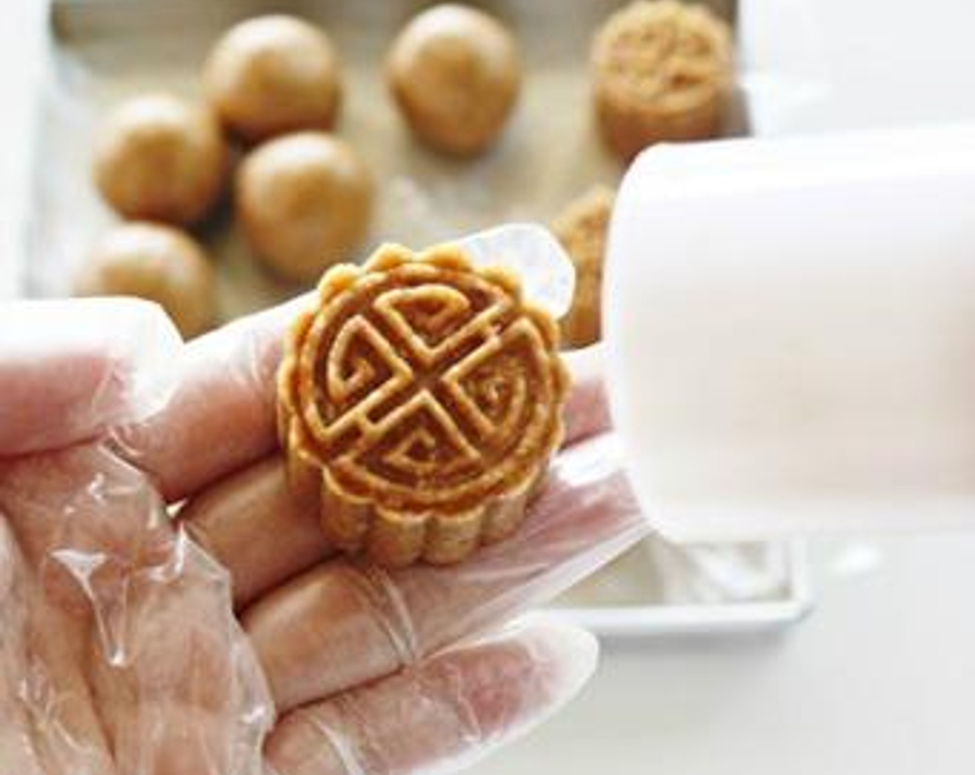 step 3 Fill the dough with filling and shape using mooncake mold - grease a little oil in the mold before placing it in.