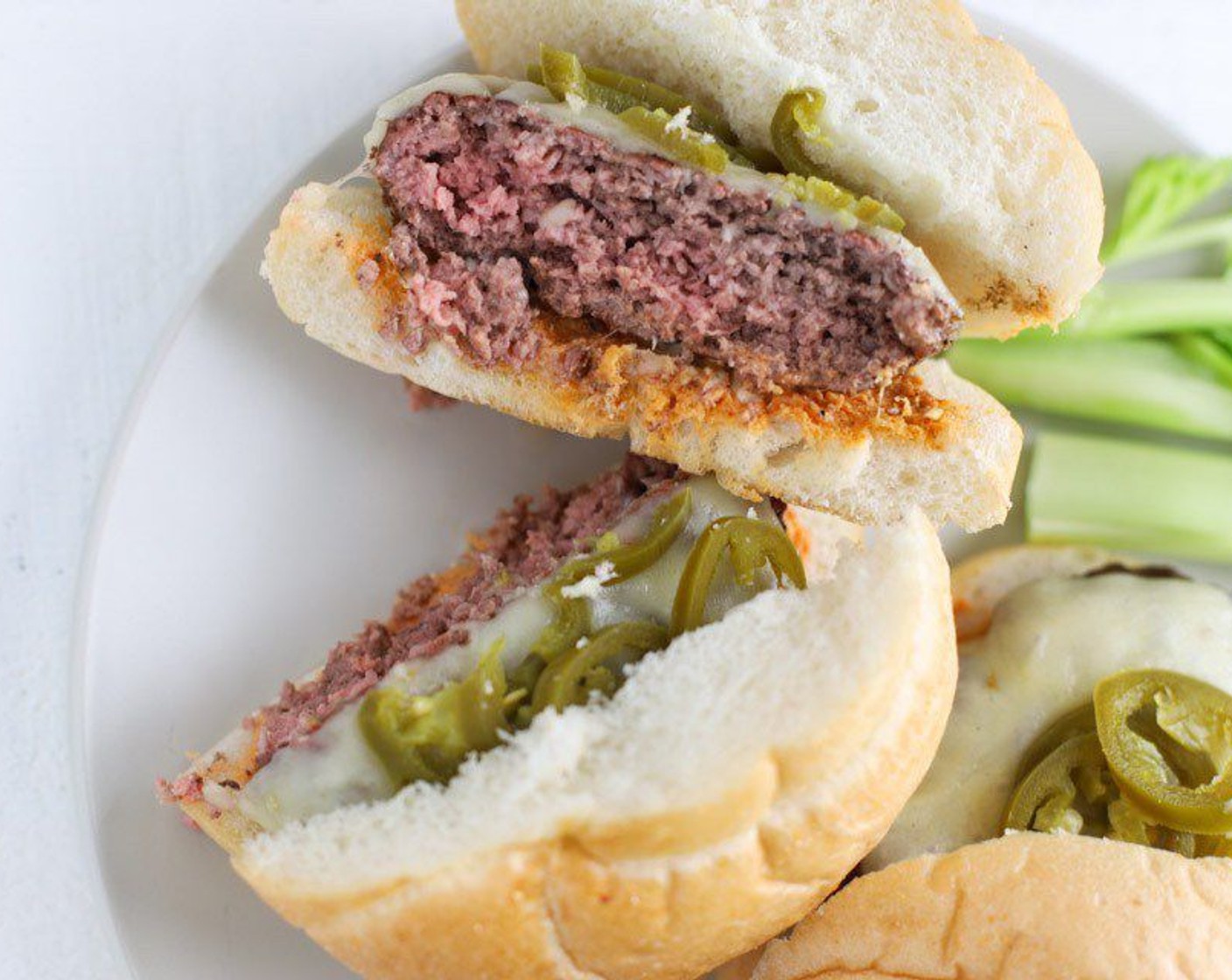 step 9 Top burgers with Pickled Jalapeño Pepper (1/2 cup). Garnish the plate with the sliced celery sticks.